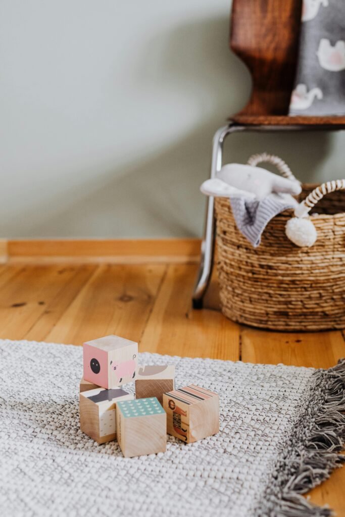 Small pile of blocks in front of a toy storage basket in a small living room 