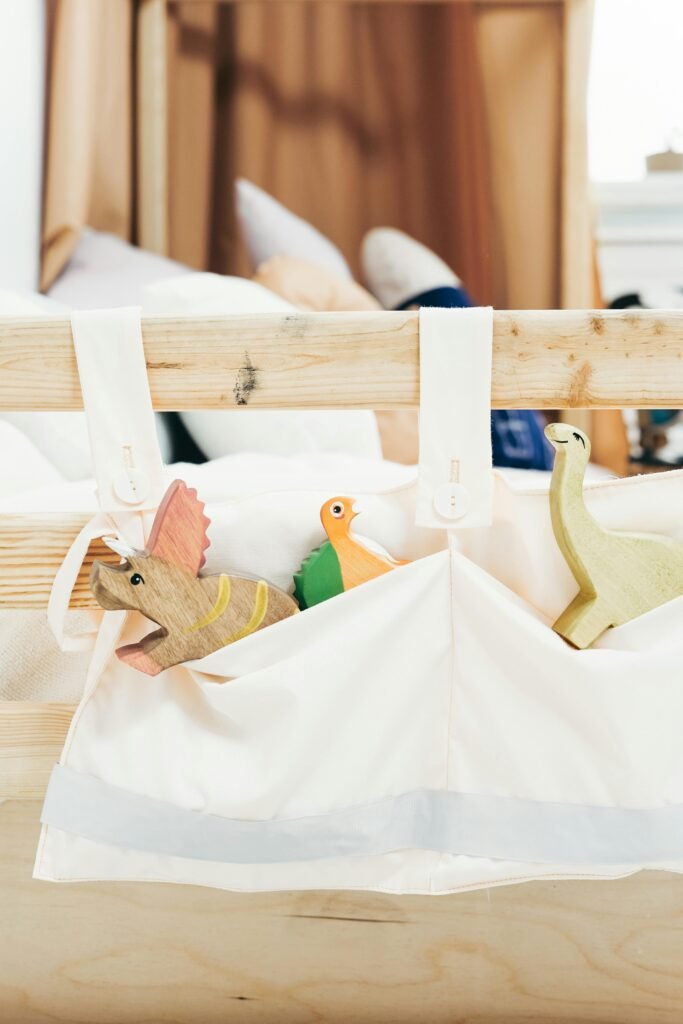 Small vertical storage baskets hanging from the end of a bed